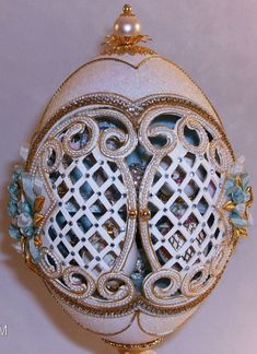 an intricately decorated egg with pearls and jewels