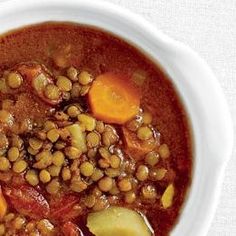 a white bowl filled with beans and carrots