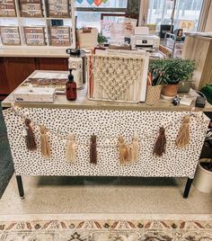 a table that has some items on top of it in front of a window with balloons