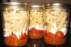 three mason jars filled with pasta and sauce