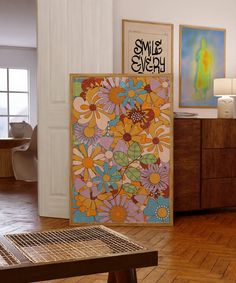 a living room filled with furniture and paintings on the wall next to a wooden table