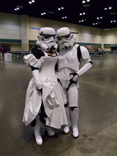 two people dressed as stormtroopers pose for a photo