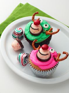 three cupcakes decorated to look like characters