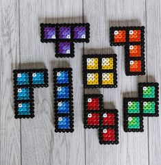 four pieces of colored beads are arranged in the shape of an 8 - bit video game