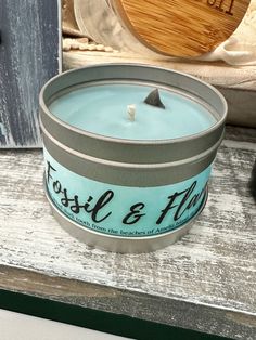 a blue candle sitting on top of a wooden table