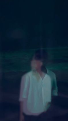 a blurry photo of a person standing in the dark