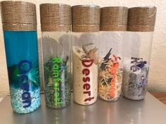 four glass jars with different types of seaweed in them on a metal countertop