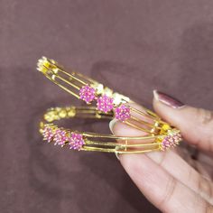 "* Handcrafted Gold Plated 4 Bangle Set. Sold as a set. * Bangles with high-quality semi-precious ruby stones. * High Quality 22K Gold Plated. Bangles Sizes : 2.6 inches = ( 2.40\" diameter of the inner circle); 2.8inches = (2.55\" diameter of the inner circle) The gorgeous gold-plated bangles set best exemplifies the careful craftsmanship done on it -- specially picked for you by Nemali Jewelry. It has a special tone of elegance attached to it. The intricate handmade design of the bangle/bracel Pink Hand Set Bracelets For Festivals, Gold Bangle With Round Beads For Wedding, Adjustable Elegant Bangle For Puja, Pink Hand Set Bangle As A Gift, Elegant Pink Bangle For Festivals, Pink Stackable Jewelry For Festive Occasions, Festive Pink Stackable Jewelry, Gold Fusion Bangle For Celebration, Adjustable Elegant Bracelets For Puja