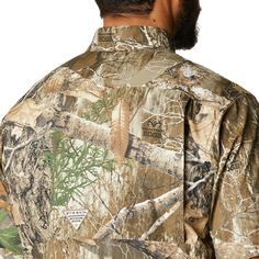 a man wearing a camo shirt with his back turned to the camera