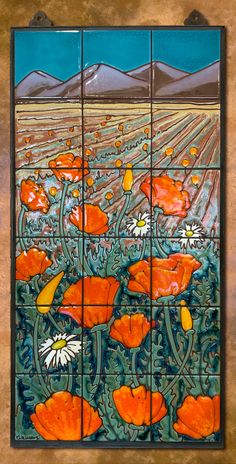 an artistic tile design with orange flowers on it's sides and mountains in the background