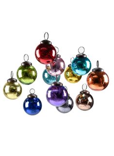 multicolored glass ornaments hanging from strings against a white background