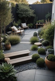 an outdoor garden with benches, plants and graveled path leading to the back door