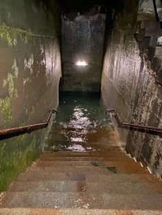 an underground tunnel with water running down it