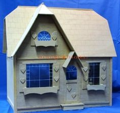 a paper model of a house with blue windows and hearts on the front window,