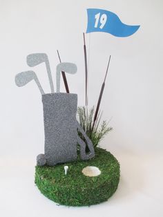 a golf bag and tees on top of a fake grass course with the number 19