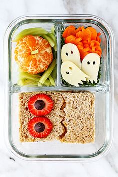 a plastic container filled with fruit and veggies