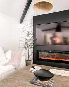 a living room with a white couch and fireplace