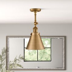 a bathroom with a sink, mirror and light fixture hanging from it's ceiling