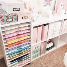 a white desk with lots of drawers and file folders on it's sides