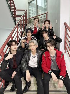 group of young men sitting on stairs posing for the camera