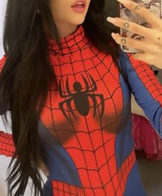 a woman in a spider - man costume taking a selfie