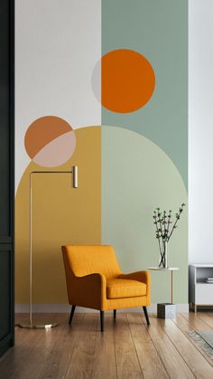 an orange chair sits in front of a wall with circles on it and a lamp next to it