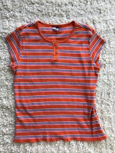 2001 Y2K TOMMY HILFIGER ORANGE STRIPED TOP SIZE L Authentic Tommy with a 2001 tag! Love the orange striped and capped sleeves! Super soft vtg feel,  Size LG ✿ Garment is measured lying flat. Compare these measurements to yours by taking measurements on a piece of clothing that fits you well. I will always post the size on the tag but it should be noted that vintage sizes usually run smaller than modern sizes. I do not accept returns for fitting issues, so please message me with any questions prior to placing your order! ✿ ✿ FREE SHIPPING for orders over $35 (Continental US only) 80's Clothes, Striped Two Piece, 70s Outfits, Stripped Tops, Fire Fits, Orange Shirt, Baby T Shirts, Dream Clothes, Striped Tee