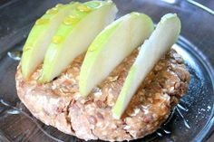 three slices of apple are placed on top of a cookie with oatmeal