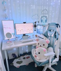 two stuffed animals sitting on a chair in front of a computer desk