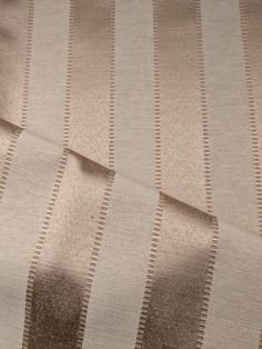 a close up view of a tan and white striped fabric