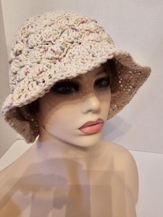 This comfortable summer hat will protect you from the sun and make a fashion statement as well. The hat is available in large which is 22"-23" circumference. It measures 9 1/2" from top of hat to edge of brim. The color is  ecru with specks of pink, purple, and aqua. Hand wash and lay flat to dry. Lightweight Wide Brim Sun Hat, One Size Fits Most, Summer Cotton Fedora With Short Brim, Natural Bucket Hat For Spring Outdoor, Cotton Fedora With Short Brim For Summer, Spring Natural Color Bucket Hat For Outdoor, Cream Bohemian Wide Brim Sun Hat, Bohemian Cream Wide Brim Sun Hat, Spring Outdoor Natural Bucket Hat, Natural Hat With Uv Protection, One Size