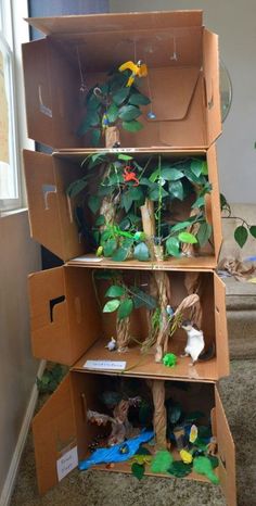 a cardboard box with plants in it on the floor