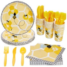 a yellow and white tableware set with bees on the plates, napkins, forks and utensils