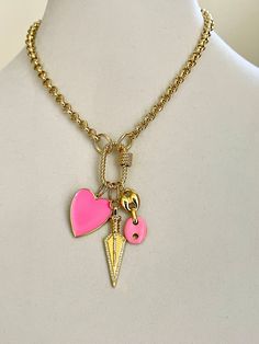 A beautiful 18k gold plated over brass Rolo chain necklace . The chain includes 3 stunning Charms which are attached to a gold rope design carabiner screw clasp. Charms- A Pink and gold enamel heart pendant. Approximate size- 25mm x 24 mm (1in x .80in) Gold and cubic zirconia Arrow- Approximate size-45mmx13mm (1.5in x .5in) Gold and Pink enamel coffee bean links-Approximate size 30mm x 12mm (1in x.4in) Wear alone or layer with other necklaces to change up the look. Perfect layering necklace. Tip Beautiful Gold Necklaces, Photo Locket Necklace, 18k Gold Necklace, Bohemian Handmade, Gold And Pink, Gold Charm Necklace, Ball Necklace, Rope Design, Pink Enamel