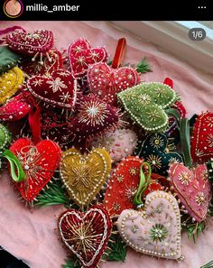 a pile of heart shaped ornaments sitting on top of a table