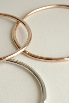 The Georgia is a timeless, minimalist bracelet style with an organic oval shape designed for constant wear. It is comfortable enough to wear even while sleeping, yet strong enough to gracefully withstand years of daily use. Each hand-soldered bracelet is shaped to mimic the contours of your forearm. Available in durable 14k gold fill, solid sterling silver, and solid 14k gold. These materials are water resistant and low maintenance. For more information, visit our Metals Encyclopedia. ✦ SIZING ( Modern Everyday Oyster Bracelet, Modern Hoop Bangle For Everyday Wear, Modern Hoop Bangle For Everyday, Sleek Round Band Jewelry For Everyday, Sleek Everyday Round Band Jewelry, Adjustable Minimalist Rounded Jewelry, Modern Adjustable Oval Bangle, Modern Polished Bangle Bracelet, Modern Rounded Jewelry With Smooth Bezel