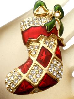 Vintage Jewelry - This is a gold tone Christmas stocking brooch with red and green guilloche enamel and clear rhinestones. It is signed Monet and measures 2" by 1.1". Red Christmas Brooch For The Holidays, Red Christmas Brooch For Holidays, Holiday Red Brooch Jewelry, Red Holiday Brooch, Red Christmas Holiday Brooch, Red Christmas Holiday Brooches, Red Enamel Brooch Gift, Red Enamel Brooch For Gift, Red Enamel Brooches For Gift