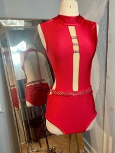 a mannequin wearing a red bodysuit and matching belt