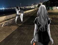 two people are walking down the sidewalk near the water at night, one is holding an orange frisbee