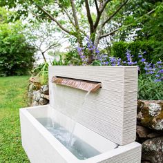 an outdoor fountain with water coming out of it