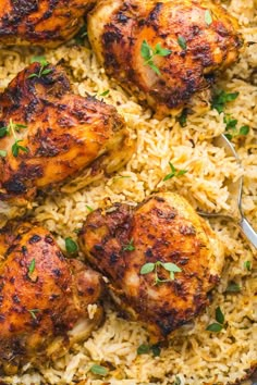 chicken and rice in a skillet with a spoon on the side, garnished with fresh parsley