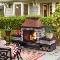 an outdoor fireplace in the middle of a patio