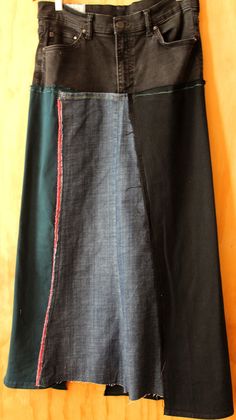 Upcycle black denim midi skirt size 8-10  This was exciting piece, turning pants into a beautiful skirt.  It is preloved slight stretch denim with stitch details . Designed by Cheryldine. Washed.  Ready to buy. Creative and chic skirt is fun street wear.  I love creating chic pieces. Every piece in my shop is made by moi and my dressform helps me with fit.  If you want in your size, I can do it.  This is one of a kind, only one available. FREE SHIPPING