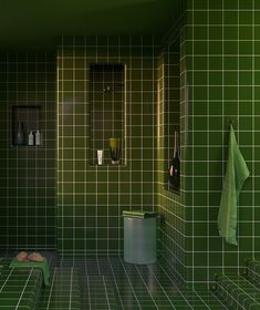 a bathroom with green tiled walls and floor