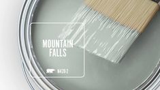 a paint can with a brush in it and the words mountain falls painted on it