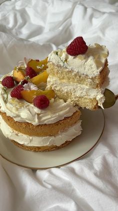 a piece of cake with white frosting and fruit on top