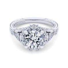 a diamond engagement ring with an intricate halo setting