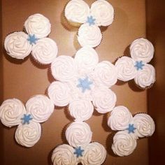 cupcakes are arranged in the shape of a snowflake