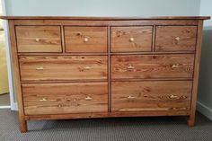 a large wooden dresser sitting in a room next to a wall and carpeted floor