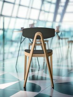 a wooden chair sitting on top of a tiled floor